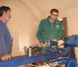 Paul demonstrating screw cutting to Matthew